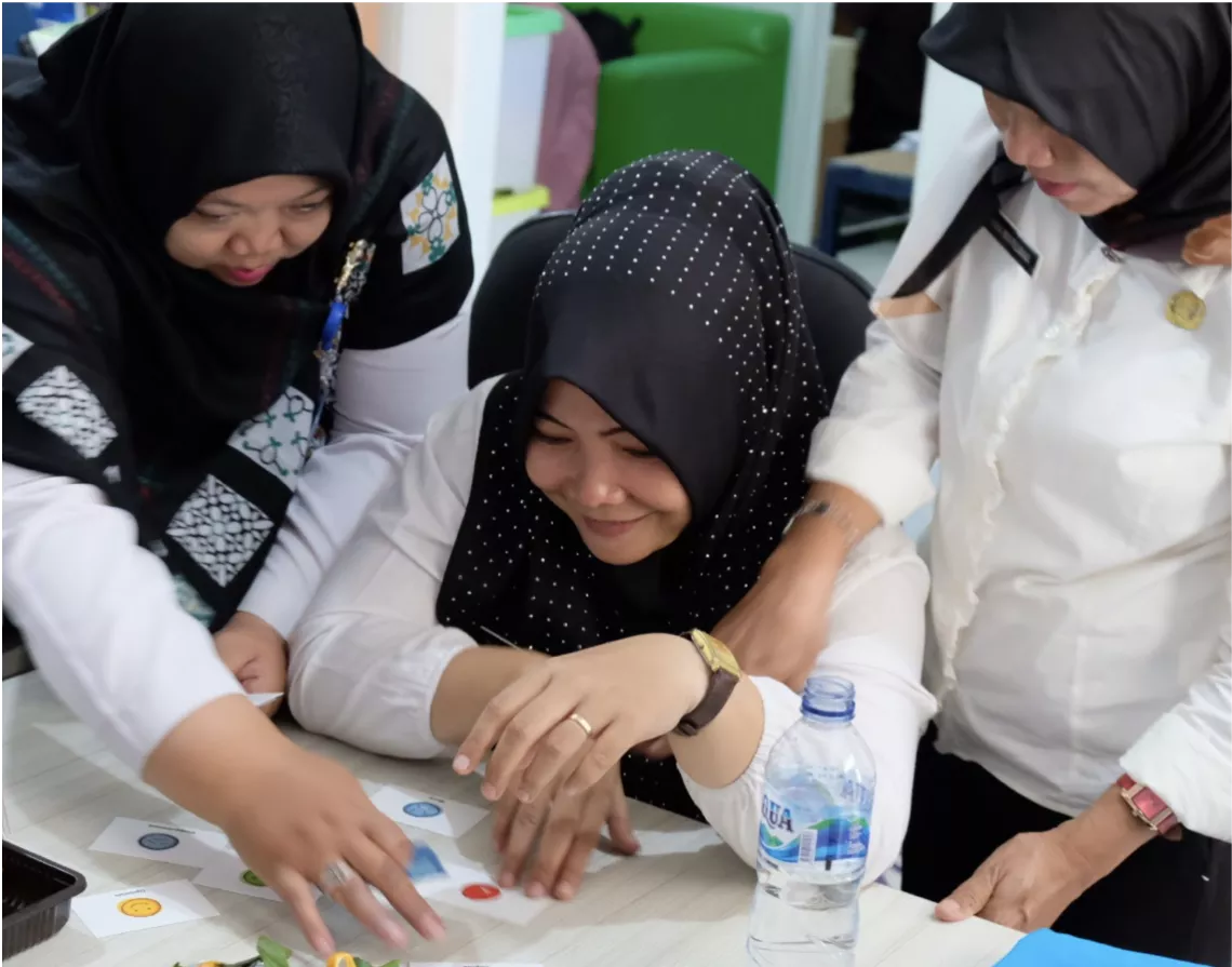 Three health workers during an interview about immunization in Sentul, Indonesia, 2019